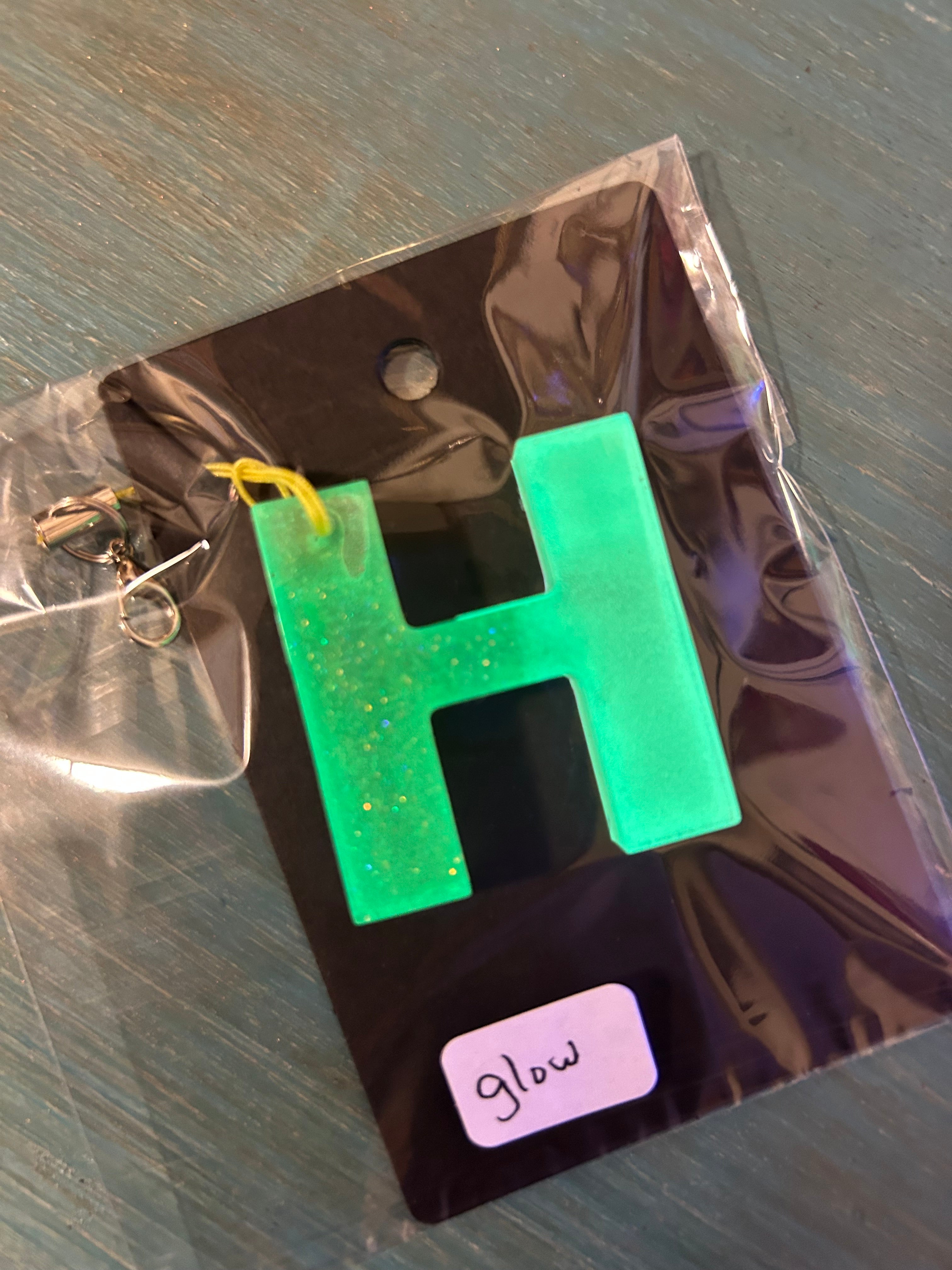 Letter charms/key chains/ bag clips (style color varies) some glow some don’t