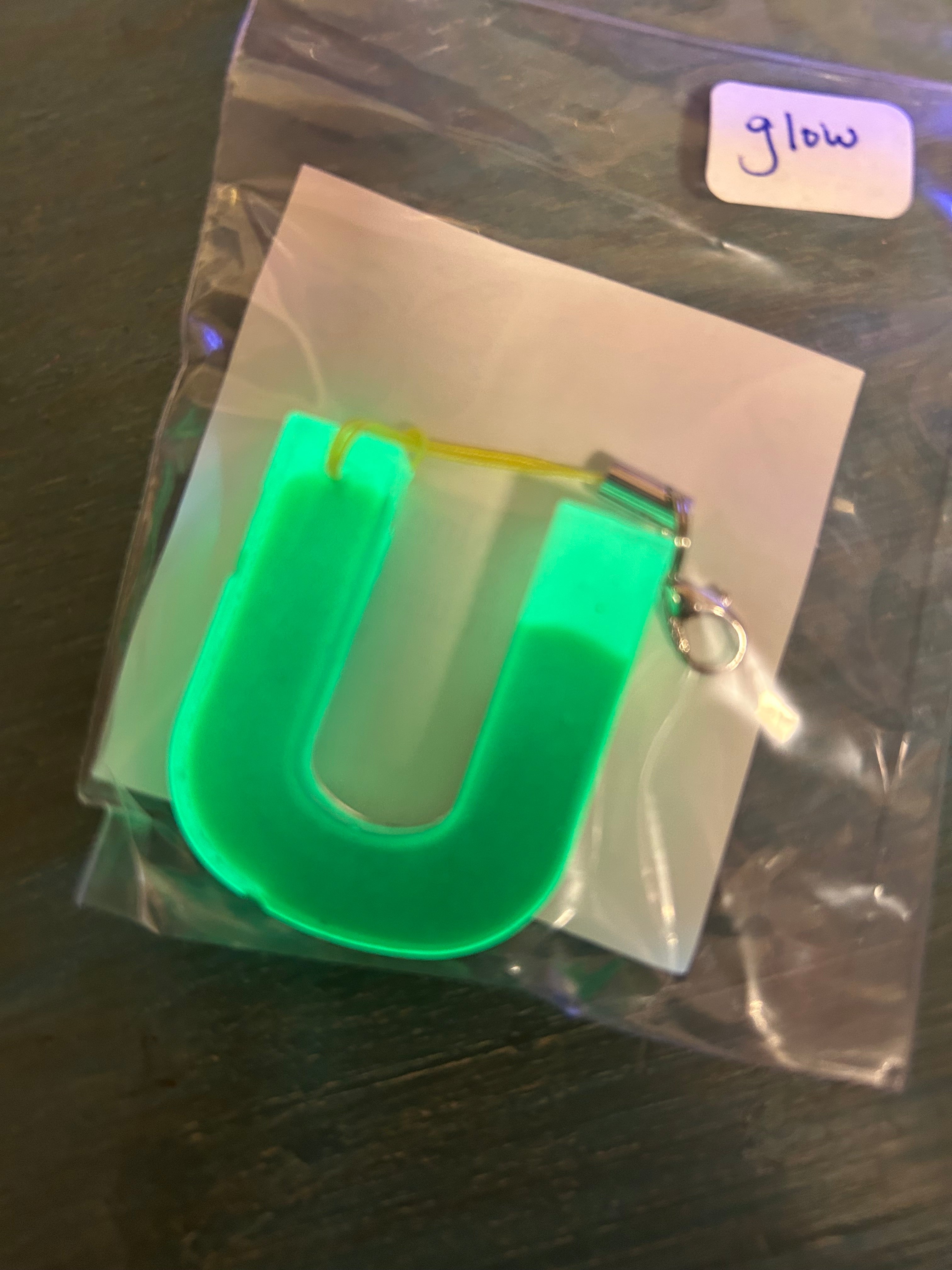 Letter charms/key chains/ bag clips (style color varies) some glow some don’t