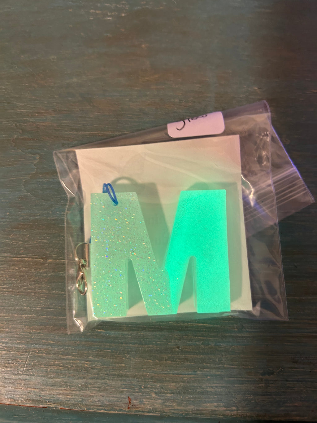 Letter charms/key chains/ bag clips (style color varies) some glow some don’t