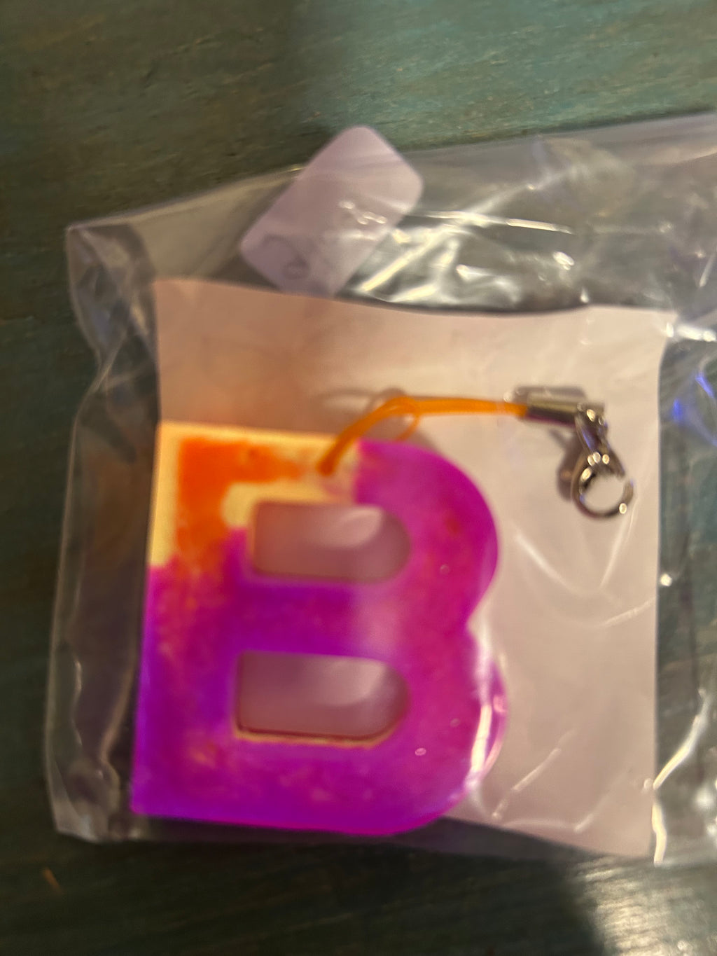 Letter charms/key chains/ bag clips (style color varies) some glow some don’t