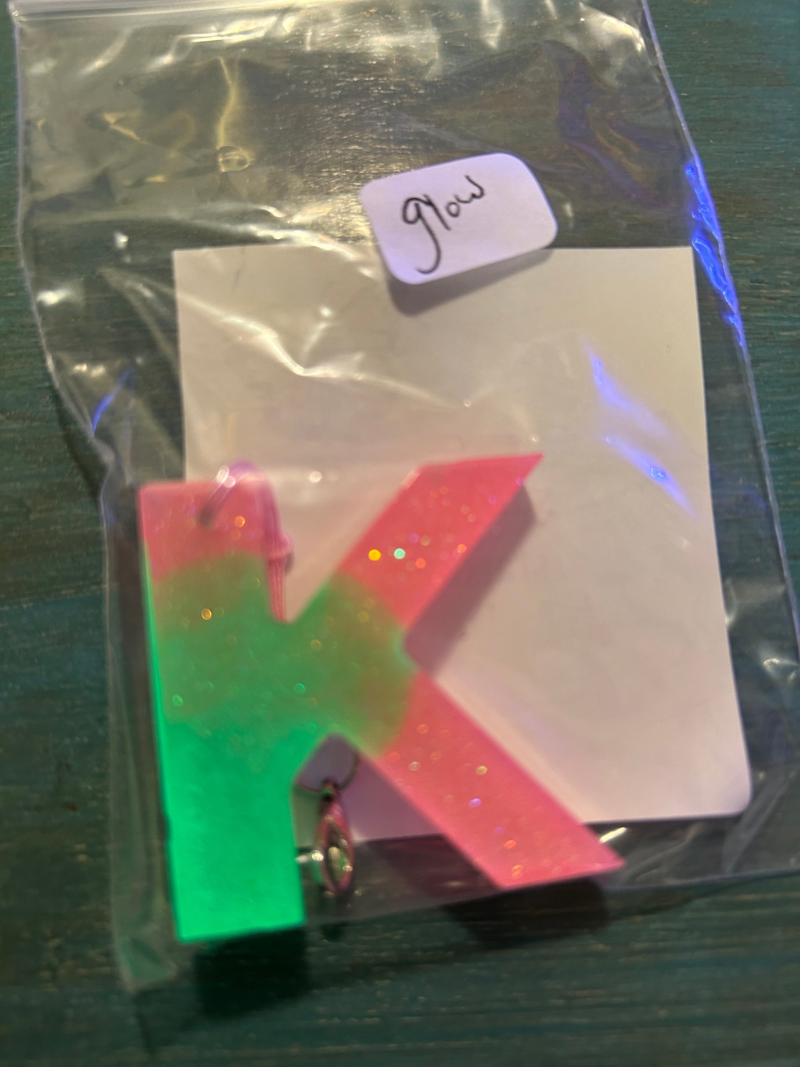 Letter charms/key chains/ bag clips (style color varies) some glow some don’t