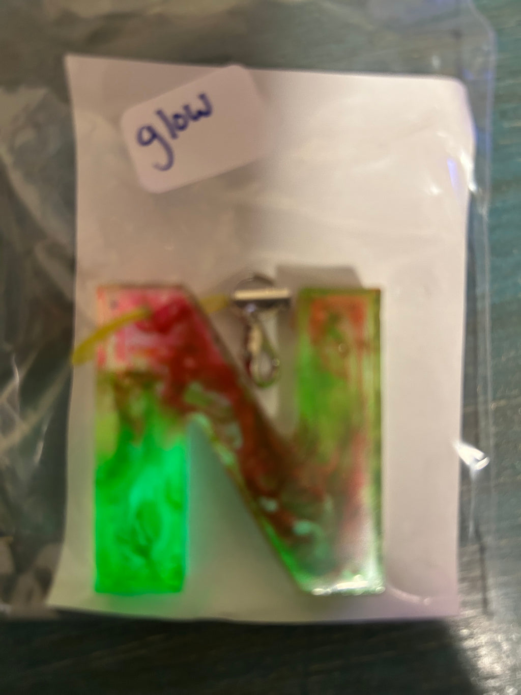 Letter charms/key chains/ bag clips (style color varies) some glow some don’t