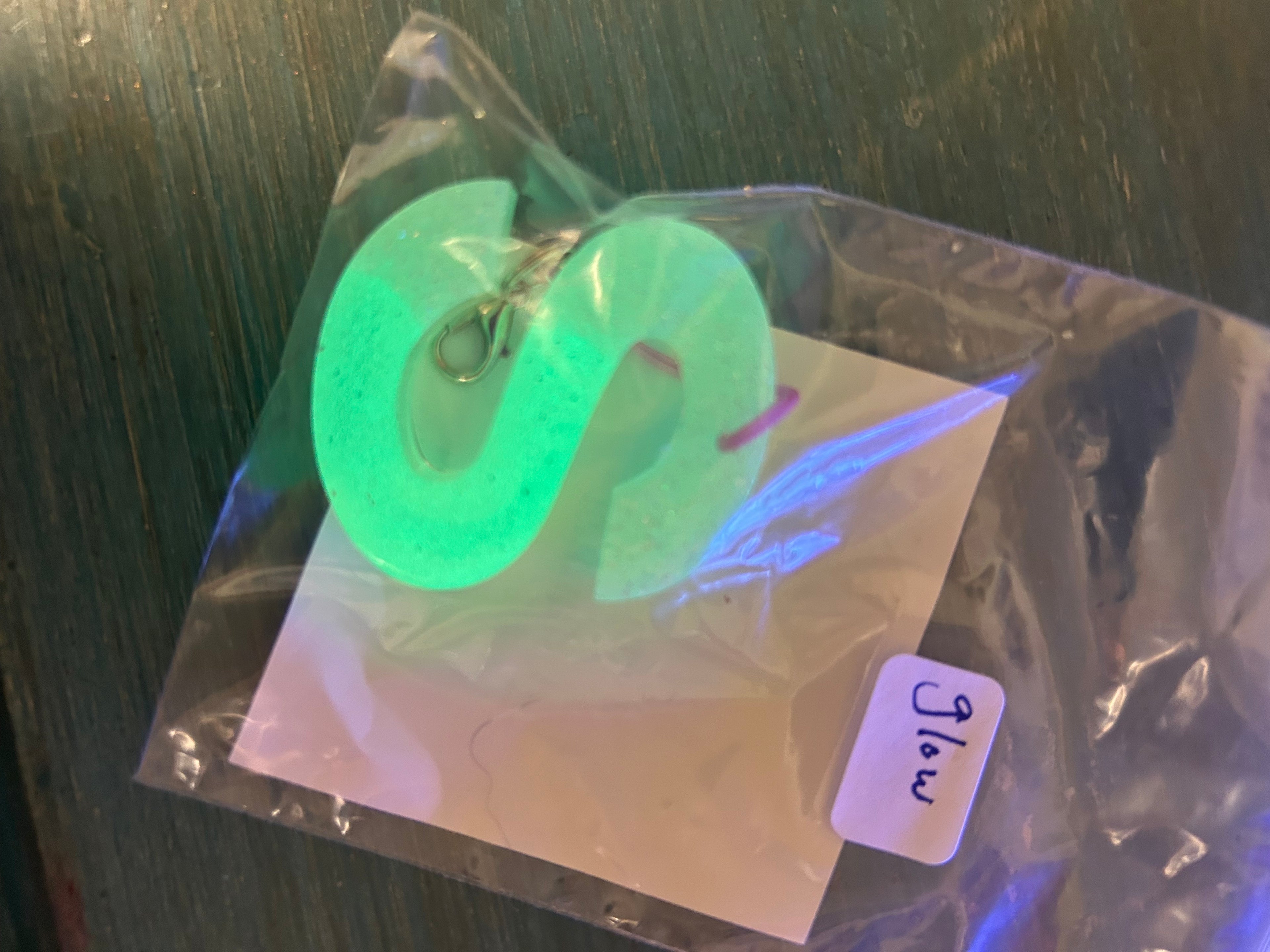 Letter charms/key chains/ bag clips (style color varies) some glow some don’t