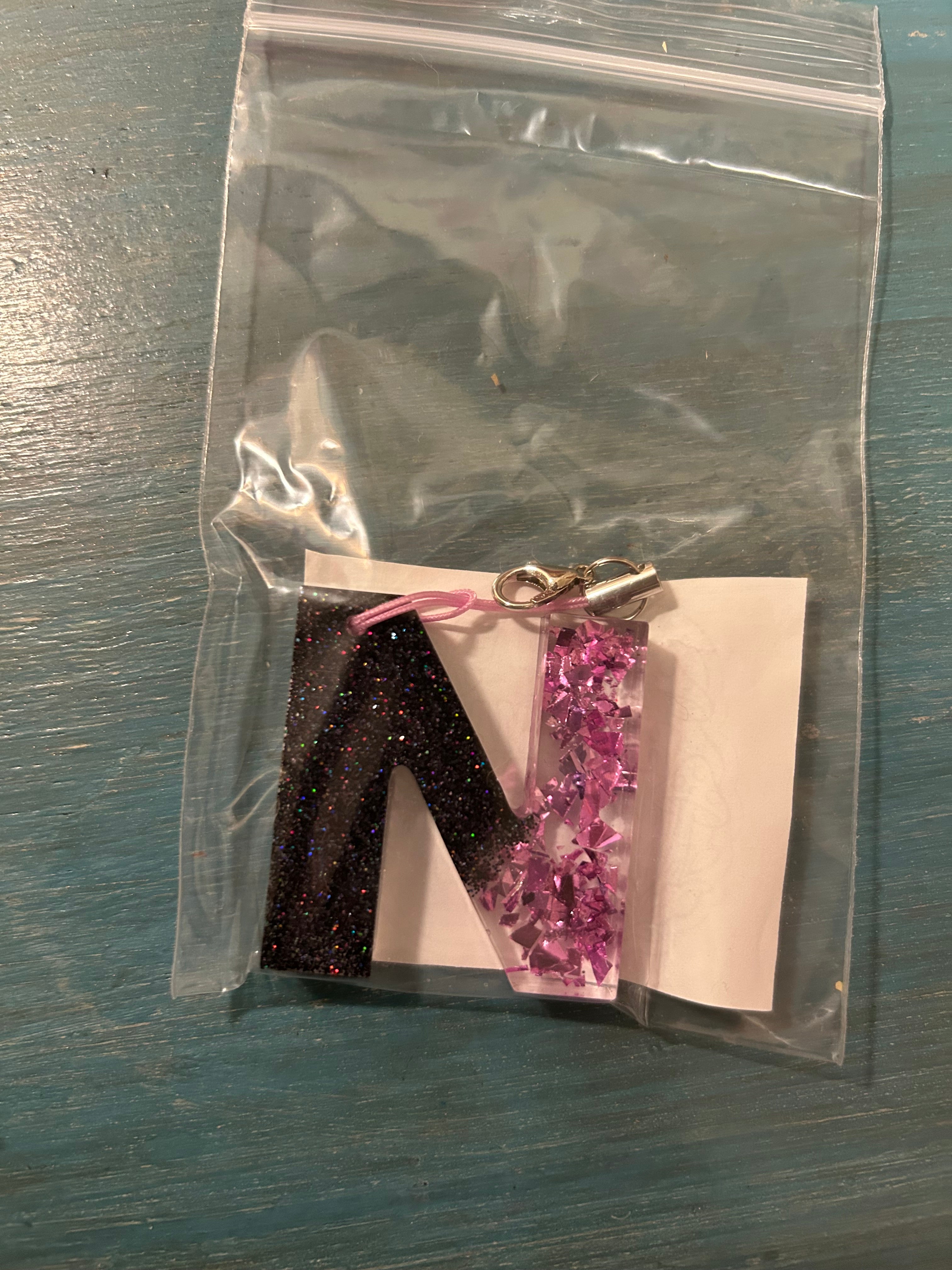 Letter charms/key chains/ bag clips (style color varies) some glow some don’t