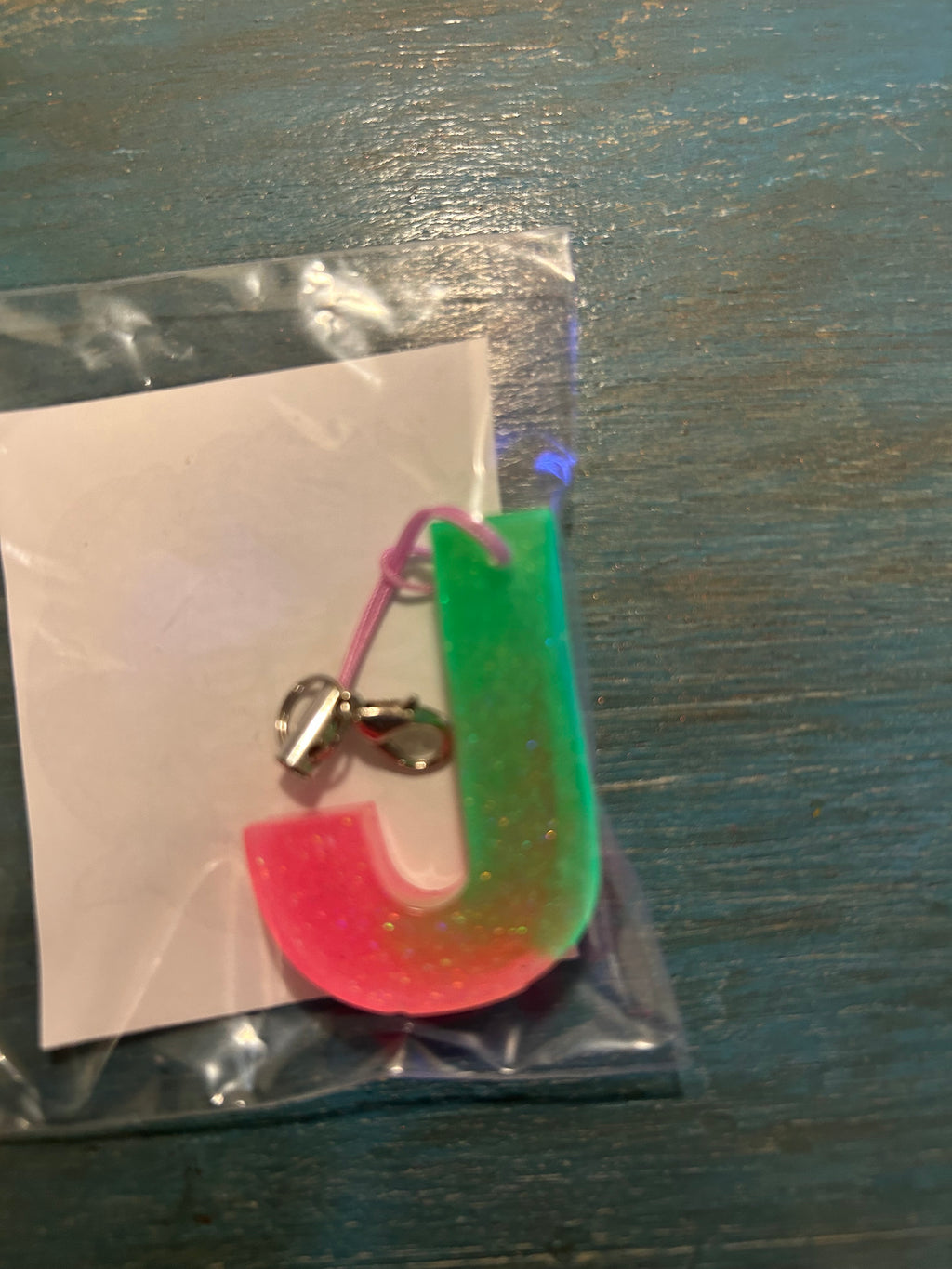 Letter charms/key chains/ bag clips (style color varies) some glow some don’t