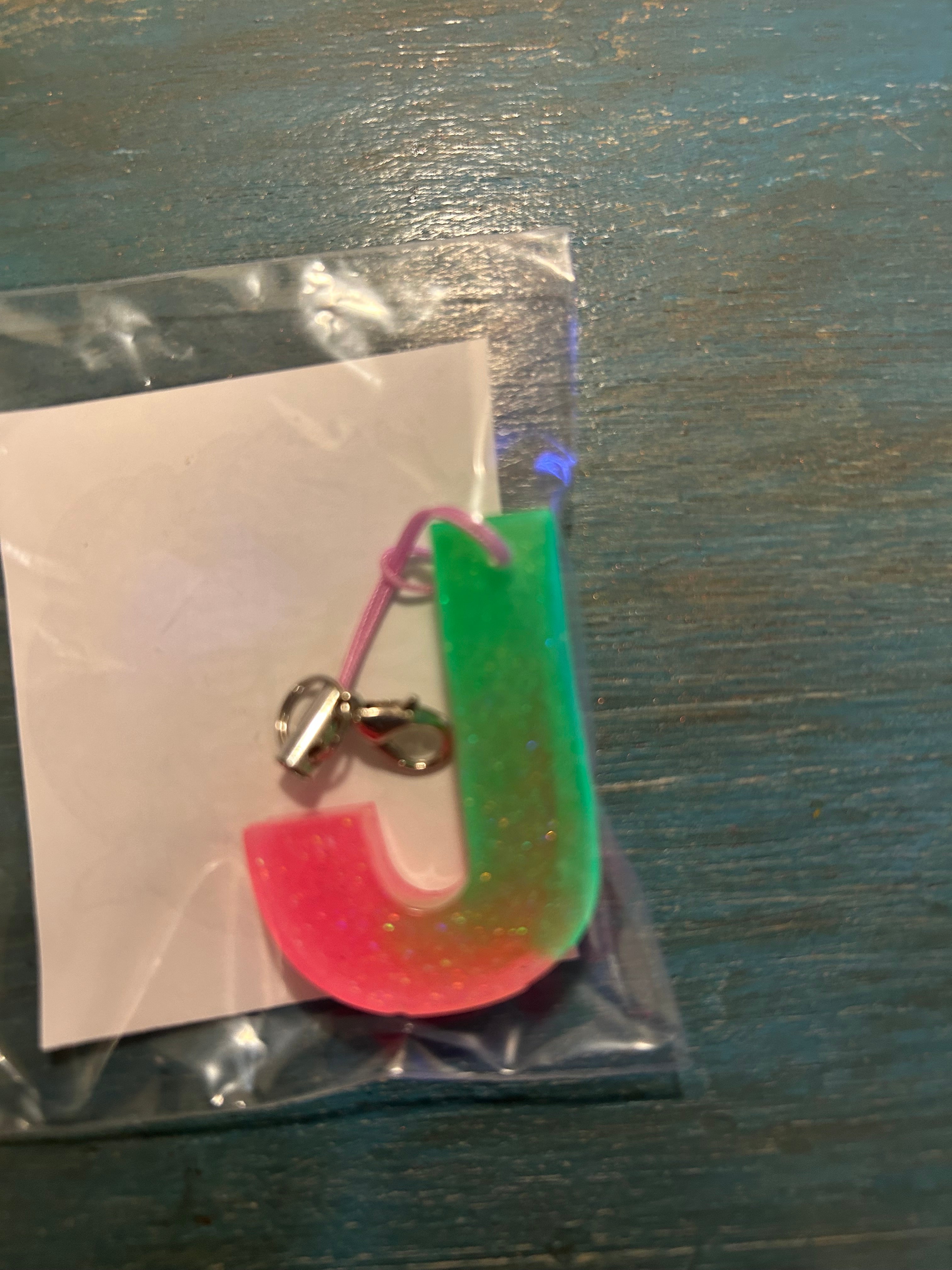 Letter charms/key chains/ bag clips (style color varies) some glow some don’t