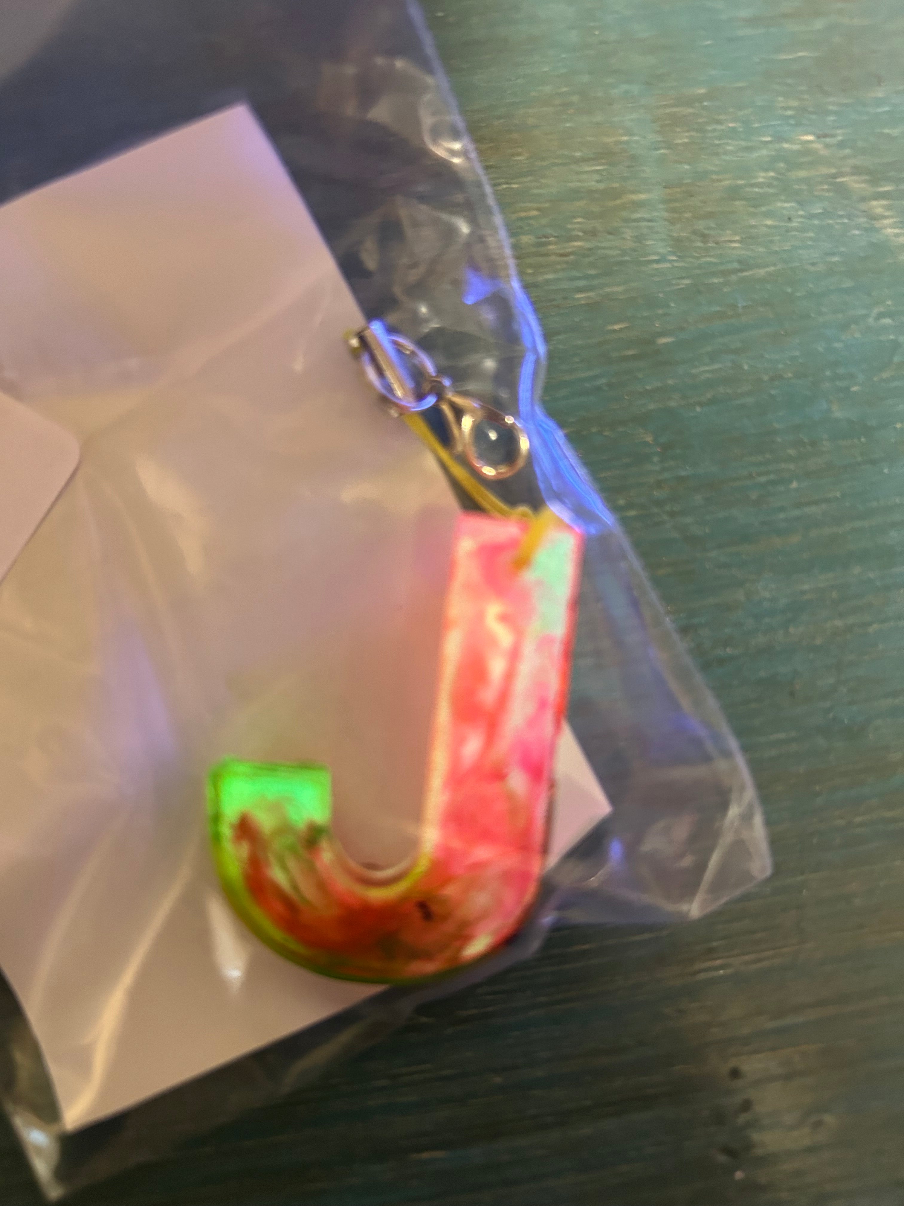 Letter charms/key chains/ bag clips (style color varies) some glow some don’t