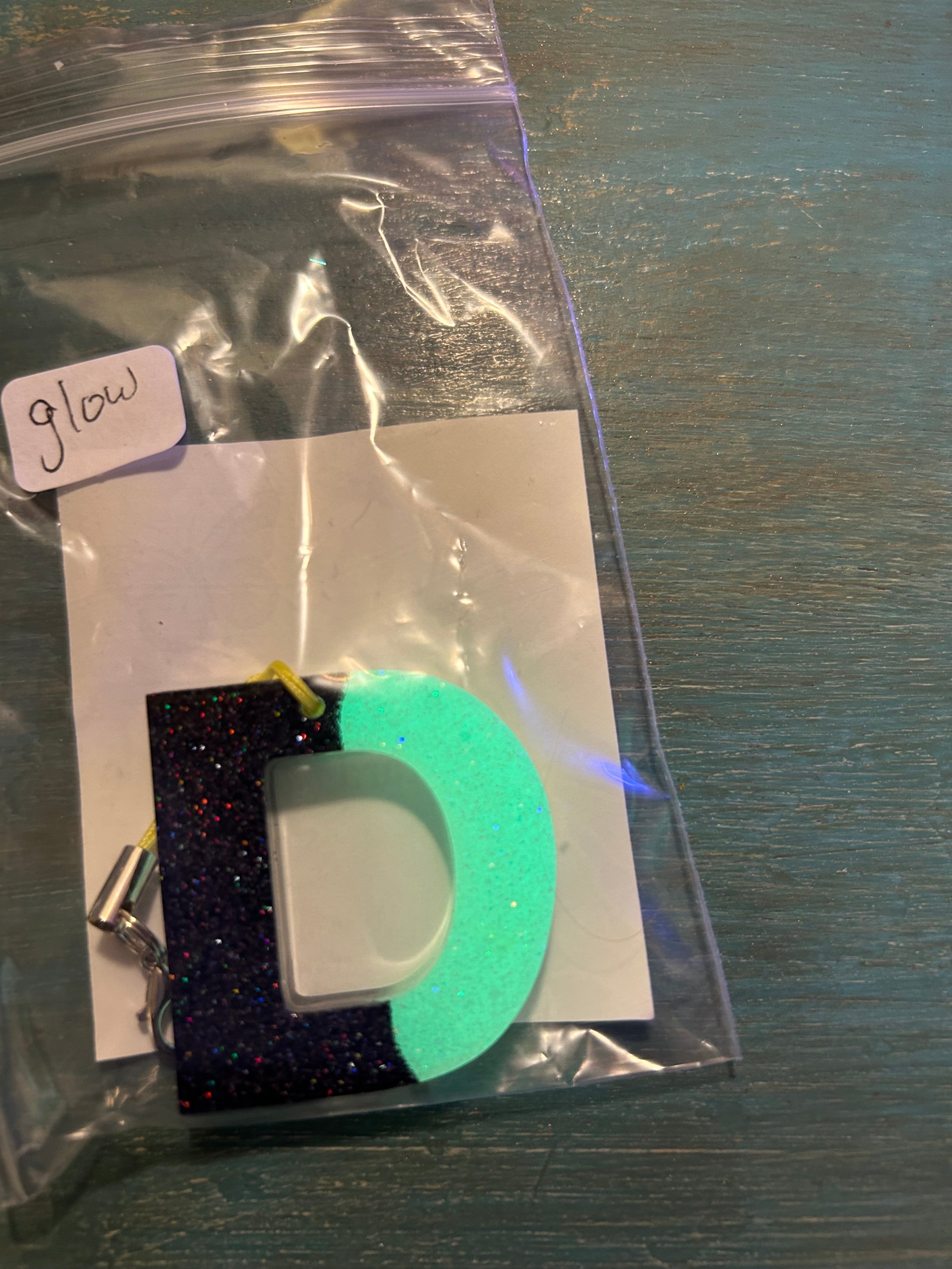 Letter charms/key chains/ bag clips (style color varies) some glow some don’t