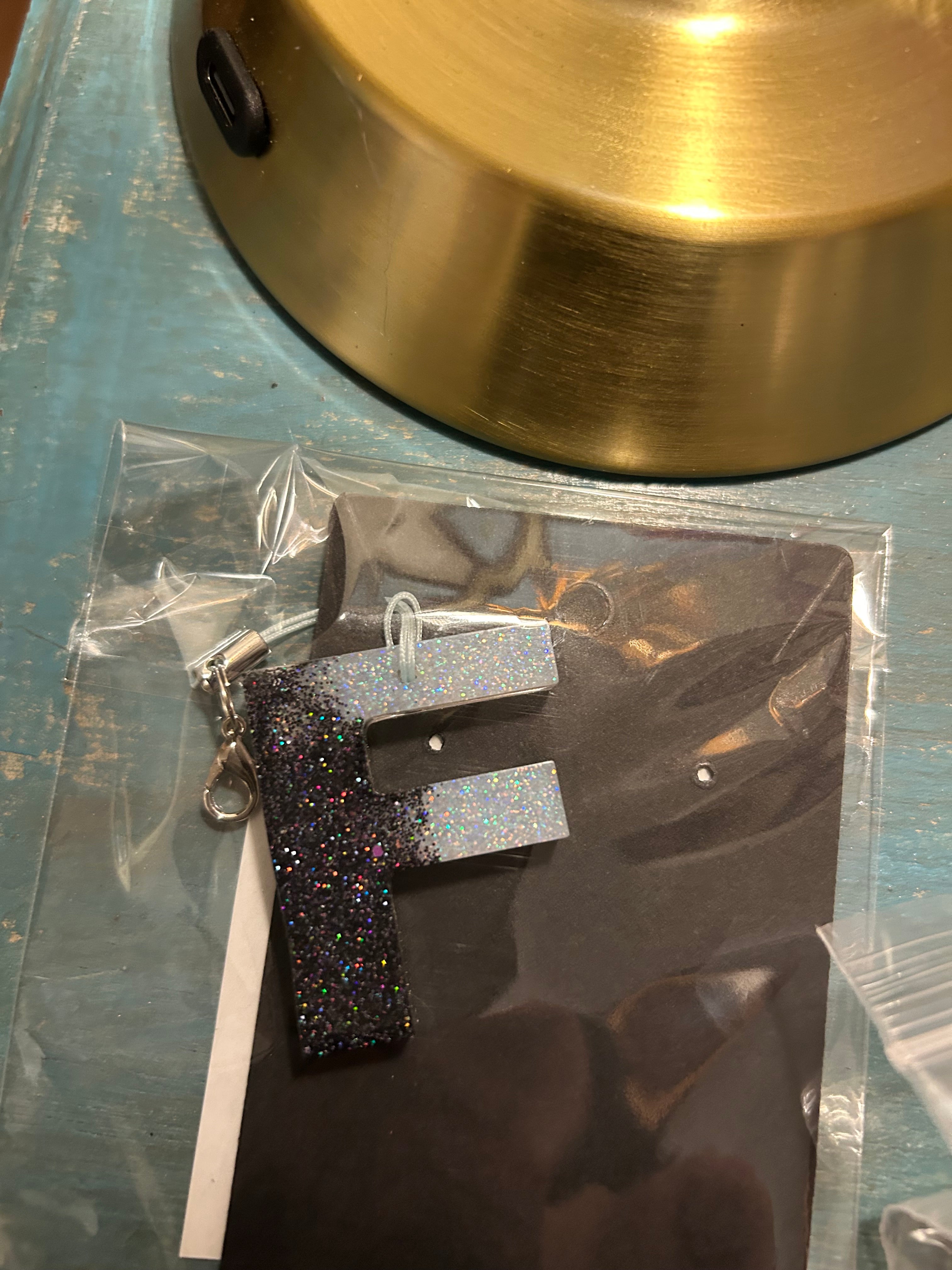 Letter charms/key chains/ bag clips (style color varies) some glow some don’t