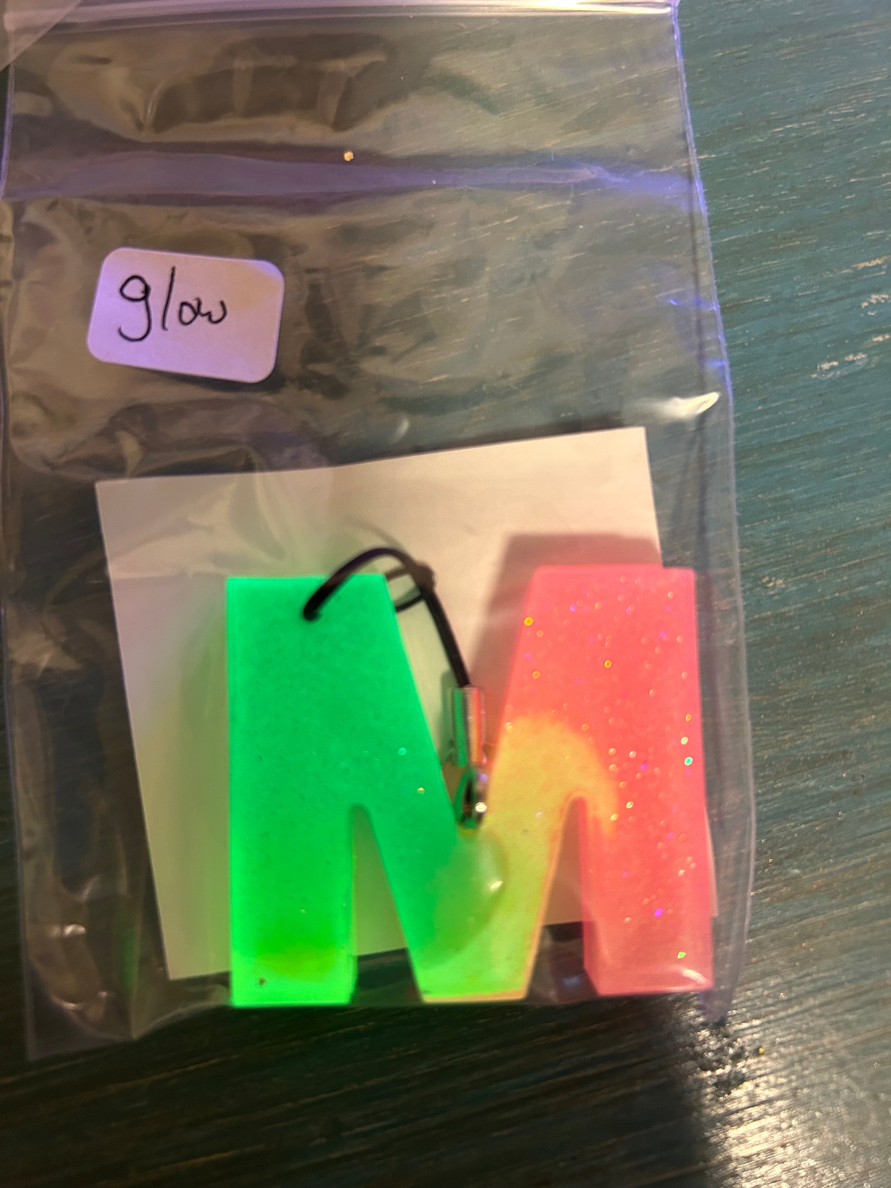 Letter charms/key chains/ bag clips (style color varies) some glow some don’t