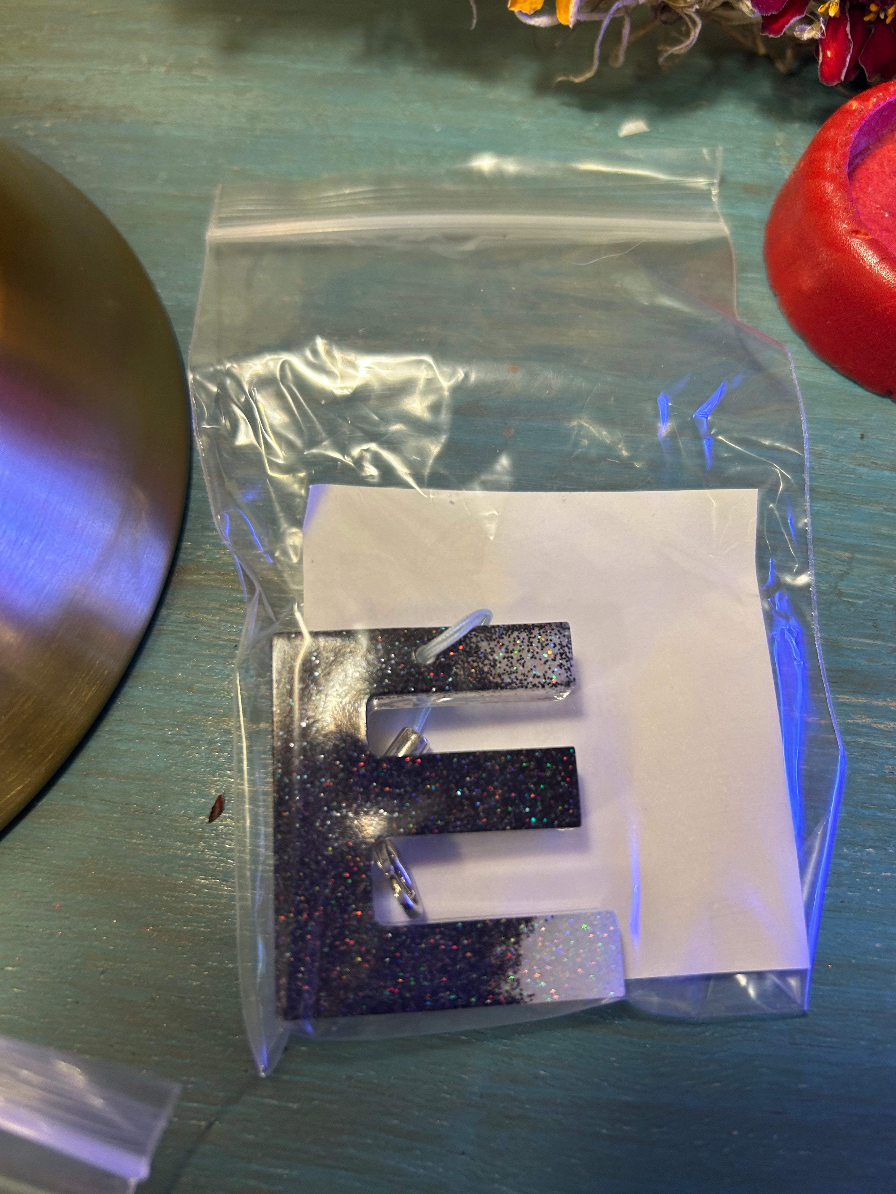 Letter charms/key chains/ bag clips (style color varies) some glow some don’t