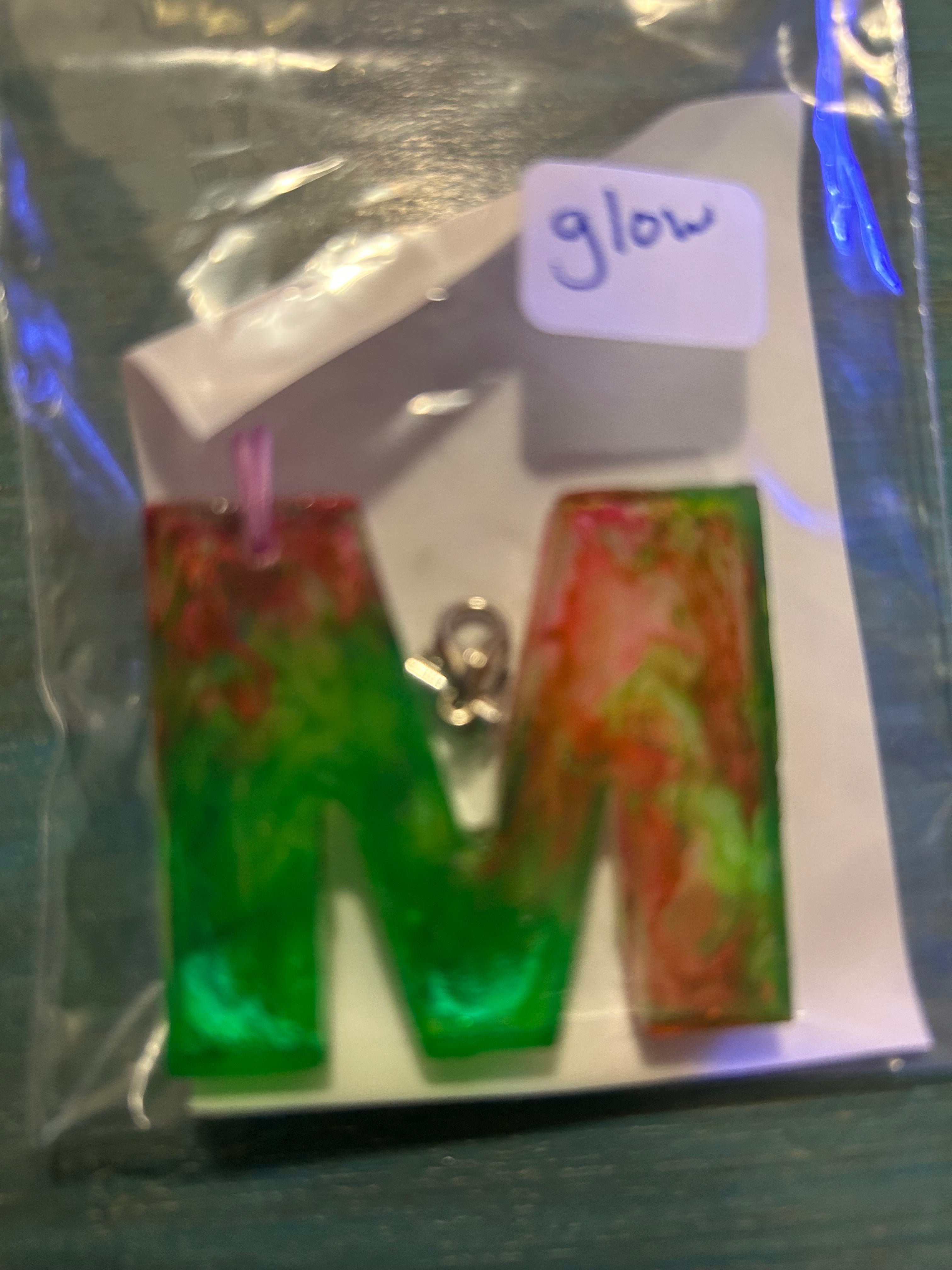 Letter charms/key chains/ bag clips (style color varies) some glow some don’t