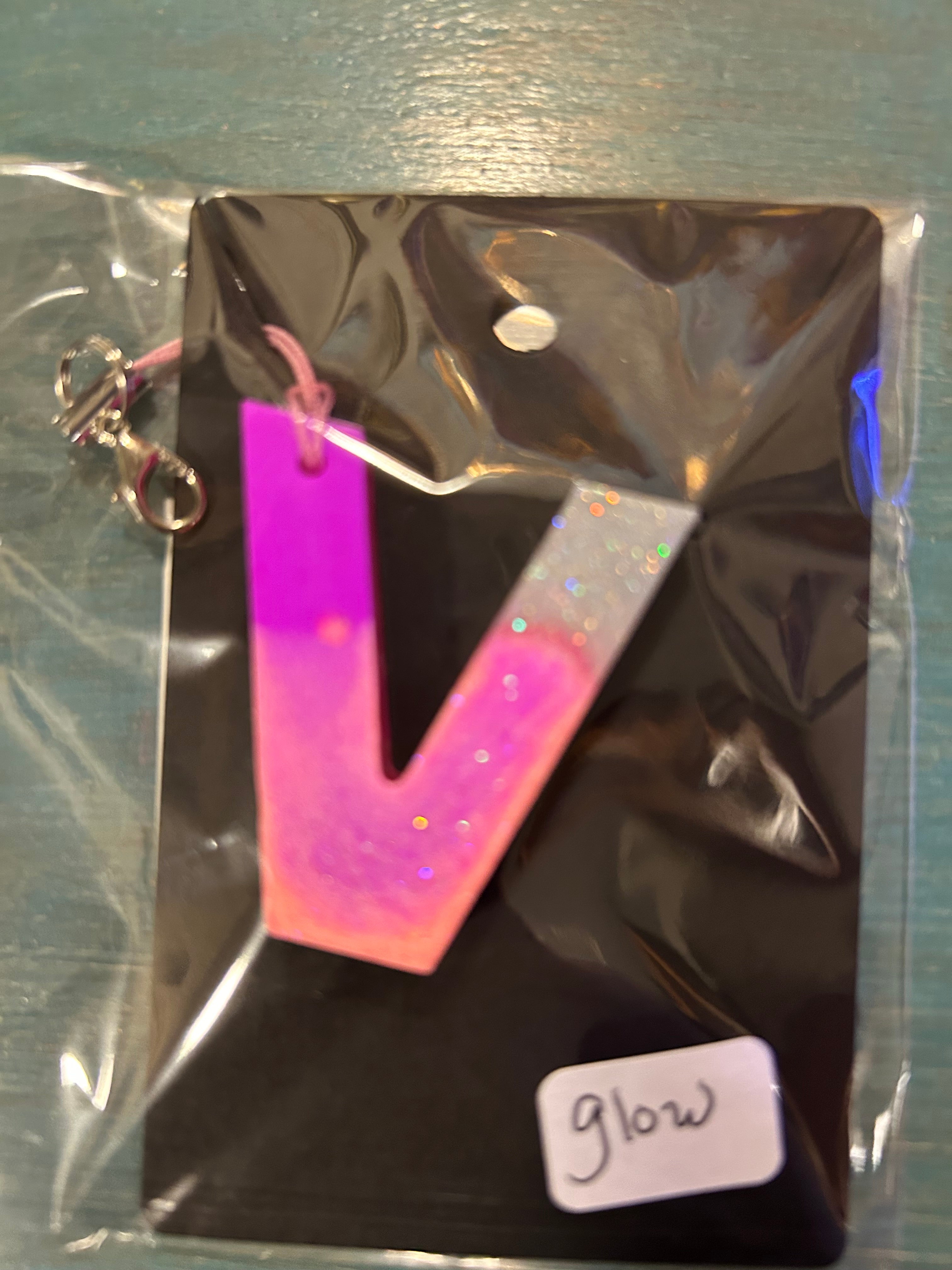 Letter charms/key chains/ bag clips (style color varies) some glow some don’t